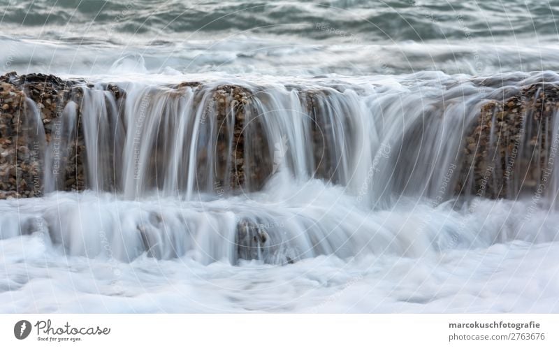 Stone wall washed over by wave Ocean Waves Environment Nature Water Island Lake Brook River Waterfall Spain Swimming & Bathing Relaxation Fluid Blue Gray