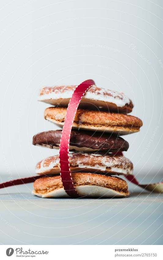 A few gingerbread cookies wrapped in red ribbon on wooden table Cake Dessert Nutrition Eating Diet Table String To enjoy Delicious Brown Baking Bakery biscuit