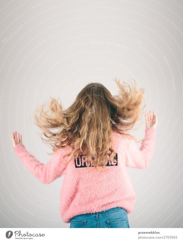 Back view of girl jumping in the air over plain background Joy Happy Relaxation Freedom Human being Woman Adults Youth (Young adults) 1 13 - 18 years Jeans