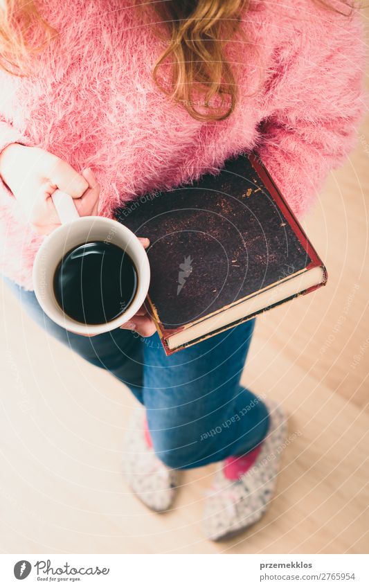 Girl holding book and cup of coffee going to relax with a book Coffee Lifestyle Relaxation Leisure and hobbies Reading Child Human being Woman Adults Book