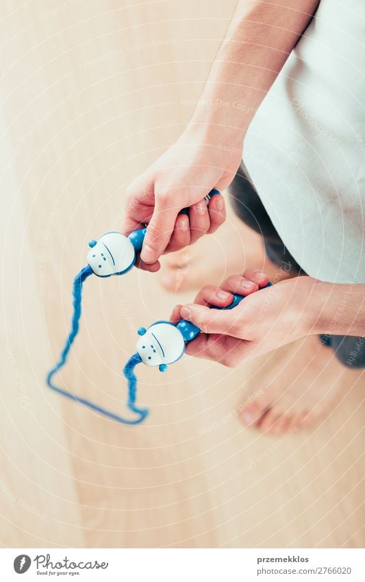 Young man holding skipping rope, doing exercises at home Lifestyle Sports Rope Human being Boy (child) Man Adults Fitness Jump Above Action Caucasian Practice