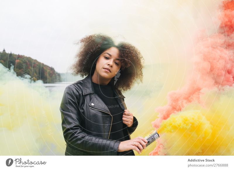 Young woman with colored smoke bombs Woman Smoke bomb Colour Jetty Nature Water Youth (Young adults) Human being Lake River Leisure and hobbies Freedom Bright