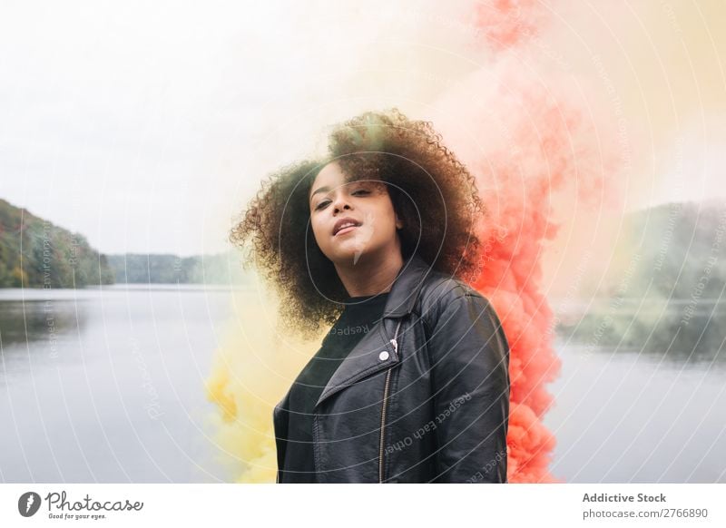 Young woman with colored smoke bombs Woman Smoke bomb Colour Jetty Nature Water Youth (Young adults) Human being Lake River Leisure and hobbies Freedom Bright