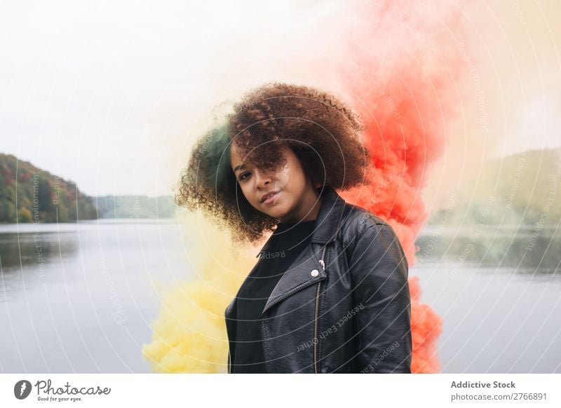 Young woman with colored smoke bombs Woman Smoke bomb Colour Jetty Nature Water Youth (Young adults) Human being Lake River Leisure and hobbies Freedom Bright