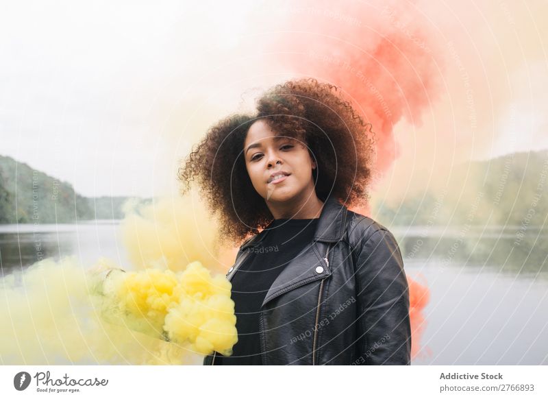 Young woman with colored smoke bombs Woman Smoke bomb Colour Jetty Nature Water Youth (Young adults) Human being Lake River Leisure and hobbies Freedom Bright