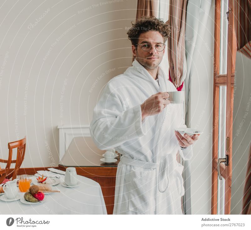 Man in bathrobe with cup Bathrobe Self-confident Style ceramic Cup Window Drinking Breakfast Room service Hotel Bedroom Home Interior design Furniture