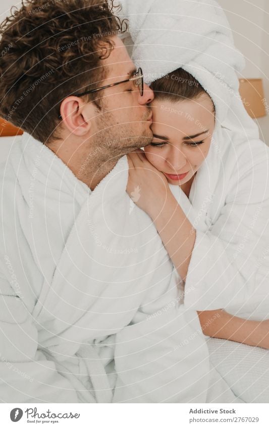 Happy couple embracing on bed Couple Bathrobe Cuddling eyes closed Hotel Room Bedroom Home Interior design Furniture Flat (apartment) Design Comfortable