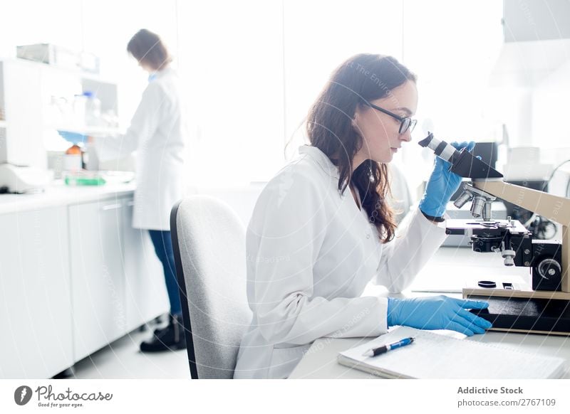 Woman looking at microscope Laboratory Work and employment Science & Research Microscope Observe Human being Scientist Medication Chemistry Technology Doctor