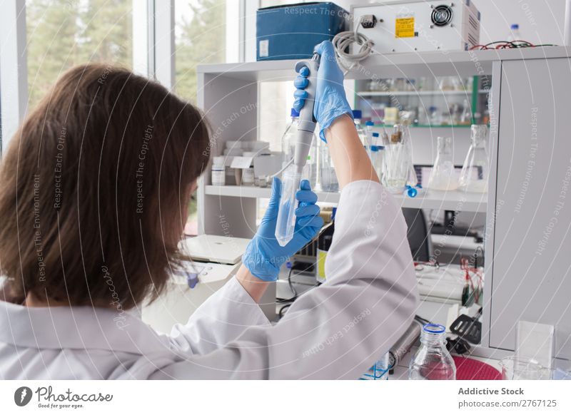 Worker putting liquid to test tube Laboratory Work and employment Science & Research Woman Test tube Liquid pouring Putt Human being Scientist Medication