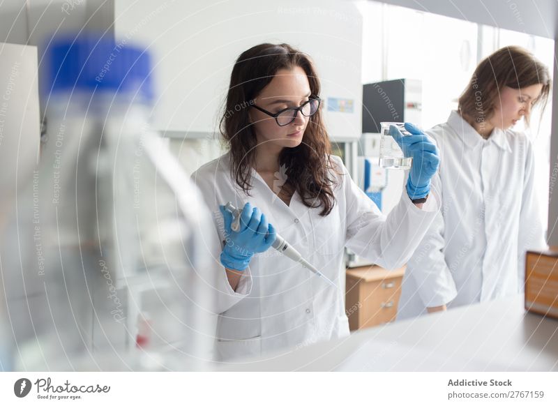 Woman holding flask in lab Laboratory Work and employment Science & Research Erlenmeyer flask Glass Scientist Medication Chemistry Technology Doctor experiment