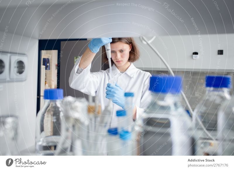 Worker putting liquid to test tube Laboratory Work and employment Science & Research Woman Test tube Liquid pouring Putt Human being Scientist Medication