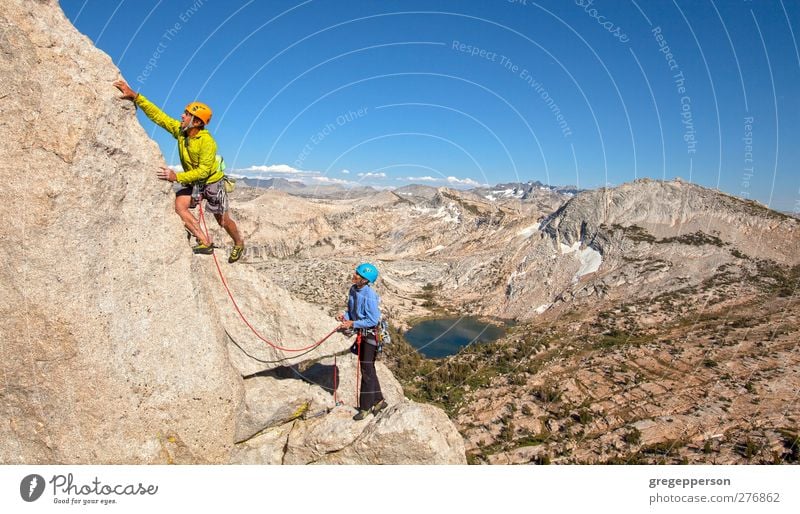 Climbing a challenging mountain. Life Adventure Mountaineering Success Rope Friendship Couple Partner 2 Human being 30 - 45 years Adults Rock Peak Helmet