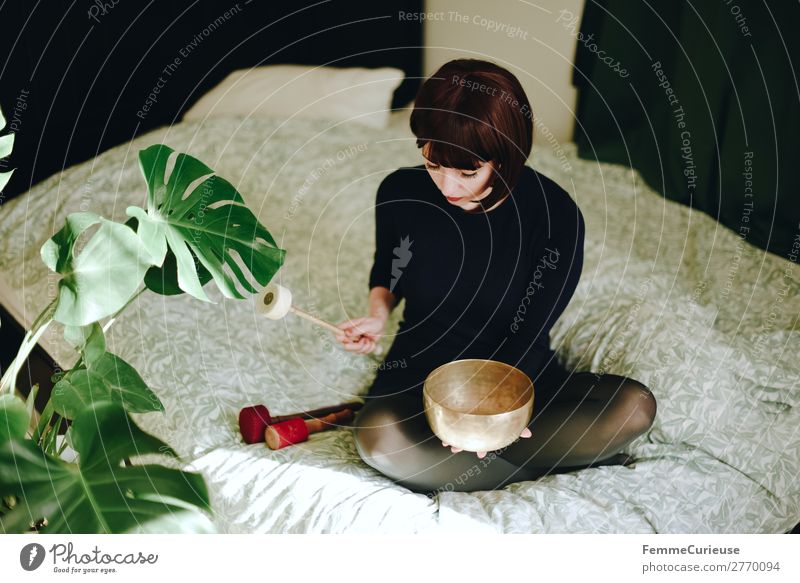 Mindfulness - Woman with singing bowl in her cozy home Lifestyle Leisure and hobbies Feminine Adults 1 Human being 18 - 30 years Youth (Young adults)