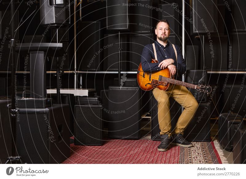 Guitarist sitting on guitar combo Man Shopping Looking into the camera seller Customer rows Musical Acoustic Equipment Human being Business Portrait photograph