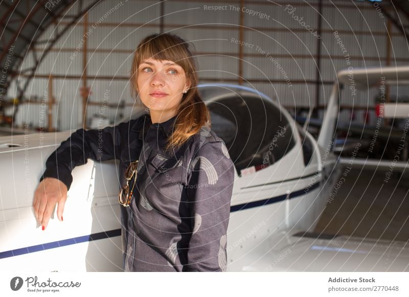 Girl posing in hangar Woman Hangar Airplane Posture Aviation Engineer Maintenance Freedom Transport Youth (Young adults) Leisure and hobbies Self-confident