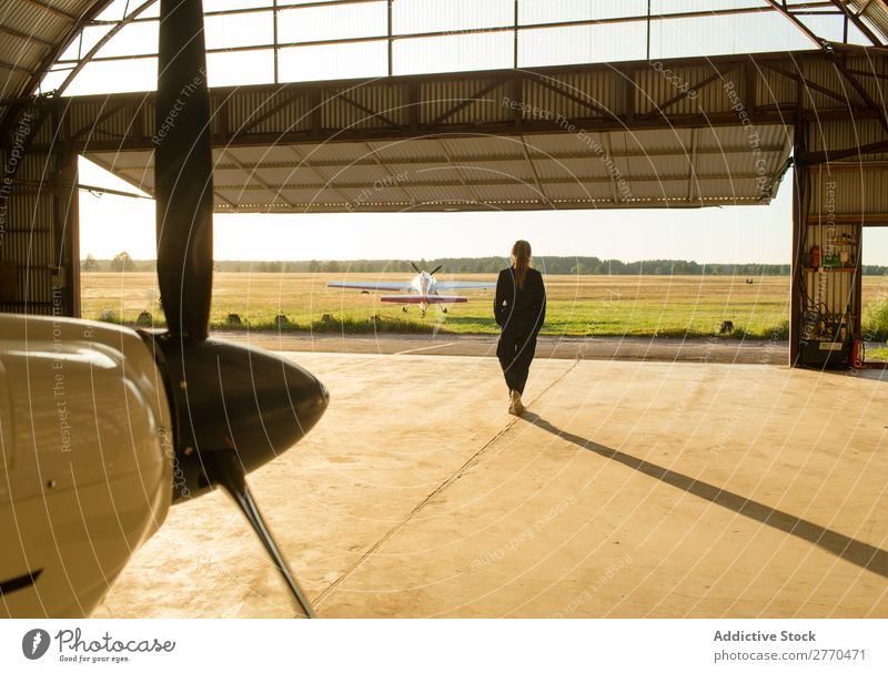 Woman posing inside of hangar Hangar Posture Aviation occupation Vacation & Travel Cheerful Freedom Transport Youth (Young adults) Adventure Landscape