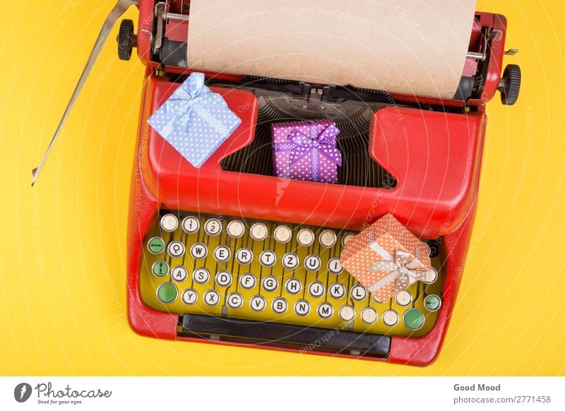 red typewriter with paper, gift boxes on yellow background Feasts & Celebrations Thanksgiving Christmas & Advent Birthday Craft (trade) Business Rope Technology