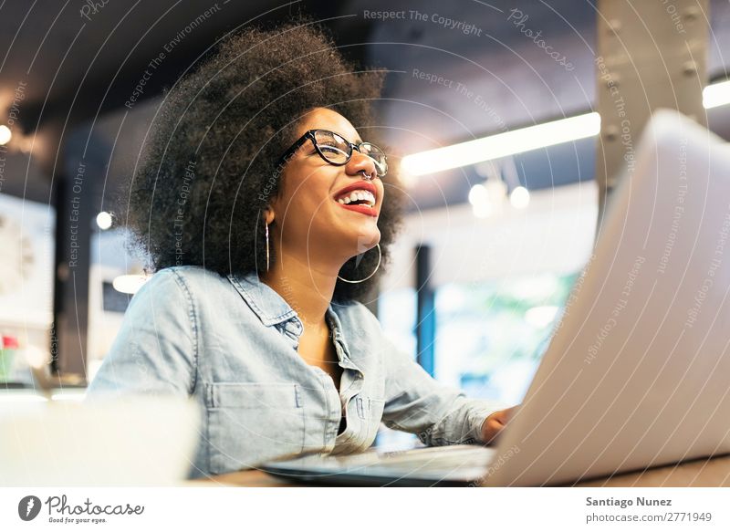 Beautiful afro american woman using mobile and laptop in the coffee shop. Woman Black African Afro Business Businesswoman Cellphone Youth (Young adults)