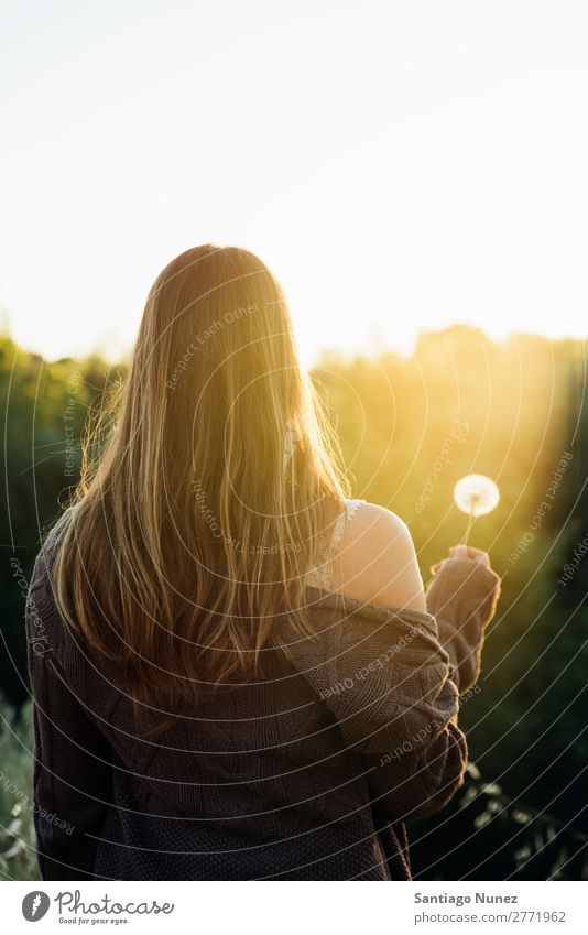 Woman blowing on a dandelion in the park. Portrait photograph Hair Spring Dandelion Hay fever Allergy Blow Pollen allergies Beautiful Natural Background picture