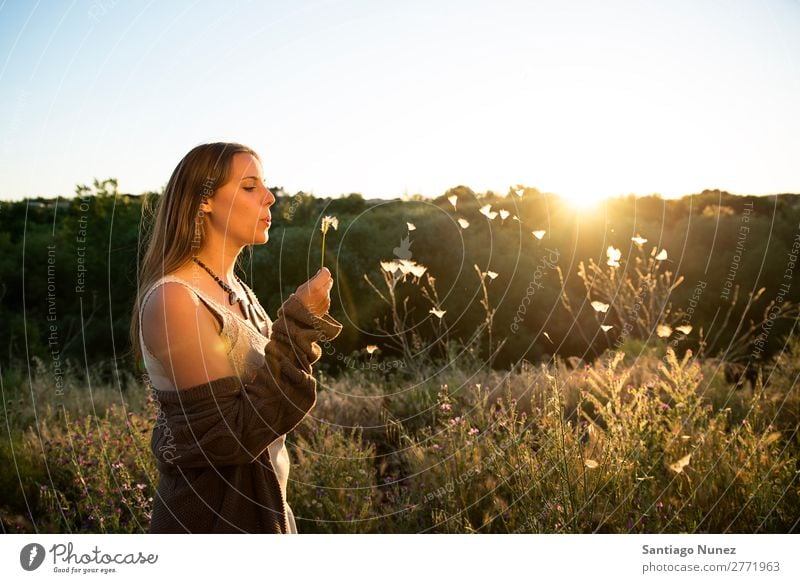 Woman blowing on a dandelion in the park. Portrait photograph Hair Spring Dandelion Hay fever Allergy Blow Pollen allergies Beautiful Natural Background picture