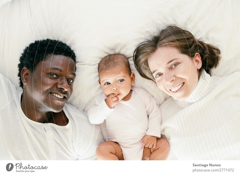 Happy Family, Mother, Father And Baby. Boy (child) Child Bed Girl Lie (Untruth) Newborn Parents multiethnic African diverse Human being interracial Caucasian