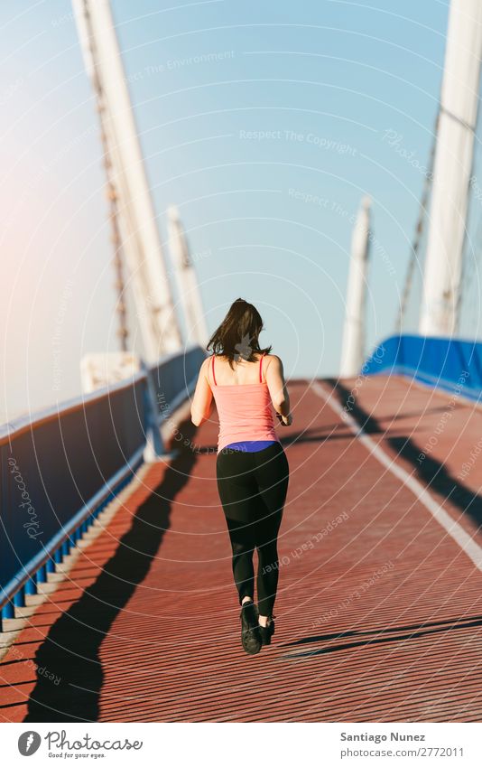 Young fitness woman runner running on city bridge. Running Runner Action Athlete Athletic Railroad Fitness Woman workout Practice Sports Strong Body Effort