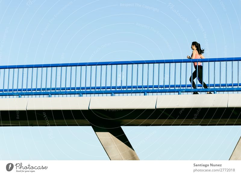 Young fitness woman runner running on city bridge. Running Runner Action Athlete Athletic Railroad Fitness Woman workout Practice Sports Strong Body Effort