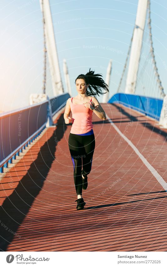 Young fitness woman runner running on city bridge. Running Runner Action Athlete Athletic Railroad Fitness Woman workout Practice Sports Strong Body Effort