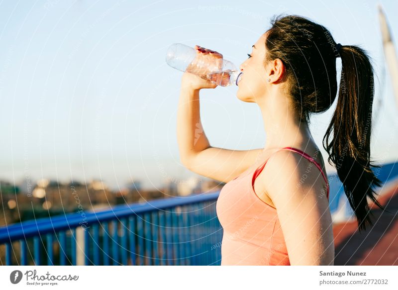 Woman resting from workout Running Runner Action Athlete Athletic Railroad Fitness Practice Sports Drinking Water Modern Strong Body Effort Flare Fuel Girl