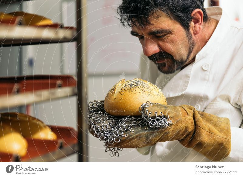 Baker kneading dough in a bakery. Bakery Business staff catering Dough Kitchen Cooking Stand chef Man Food Profession occupation preparing Make Industrial