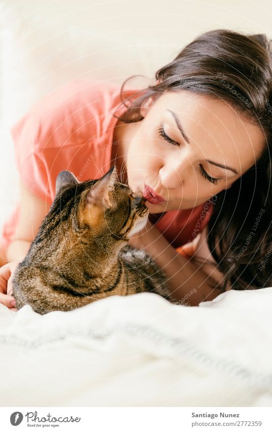 Happy woman kissing her cat. Cat Woman Girl Embrace Animal Pet Kissing Kitten Cute Beautiful Human being Love Home Face Fashion White Hair Caucasian Smiling