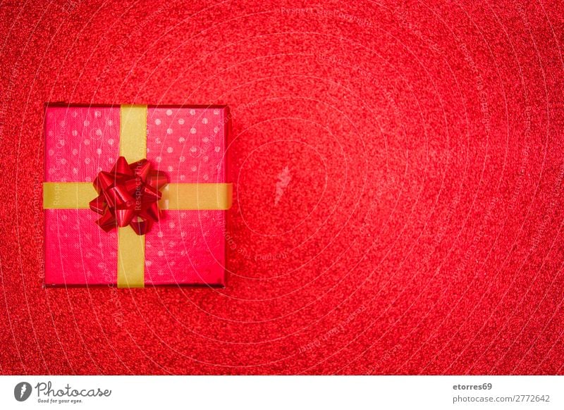 Christmas red gift presents on red glitter background. Gift Box Carton Christmas & Advent Present Day Red Glitter Gold String Paper Wrapper