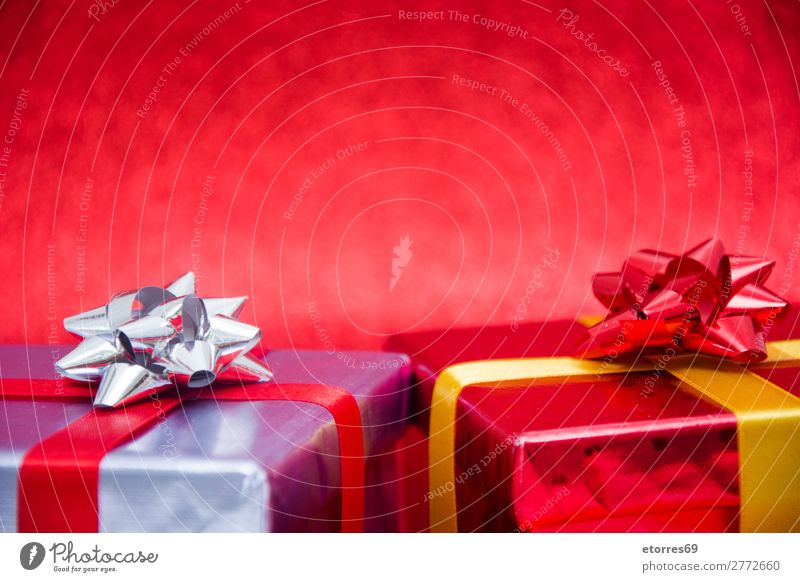 Christmas gifts presents on red glitter background. Copyspace Gift Box Christmas & Advent Present Day Red Glitter Silver String Paper Wrapper