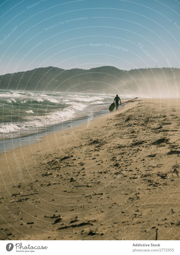 Surfer walking on beach Human being Beach Surfing Tide Walking Landscape Freedom Aquatics Nature Water surfboarding Virgin forest Natural Tropical Inspiration