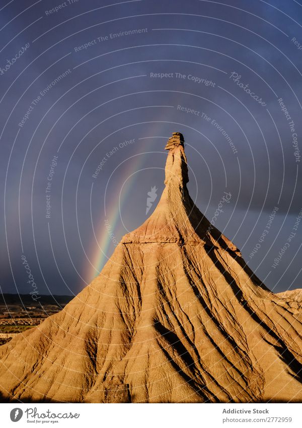 Shaped rock in overcast Landscape Rock Cloud cover Rainbow Mountain Deserted Weather darkness Structures and shapes Environment Storm Nature Highlands Cliff