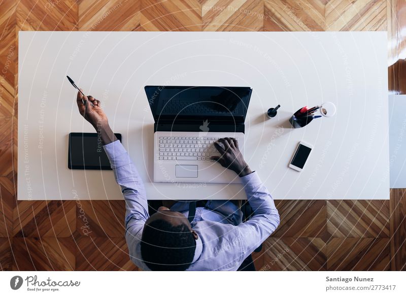 Young African Businessman Working. Adults American Architect at work Black Action Easygoing Company Computer Notebook Self-confident Designer Desk Entrepreneur