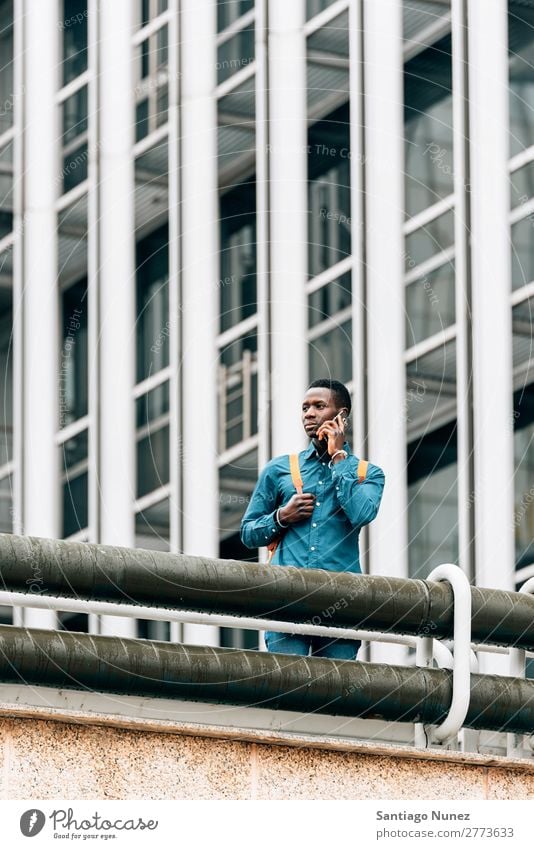 Businessman in the Street. Man Black African American Cellphone Youth (Young adults) Telephone Happy Mobile Exterior shot PDA Office Human being Communication