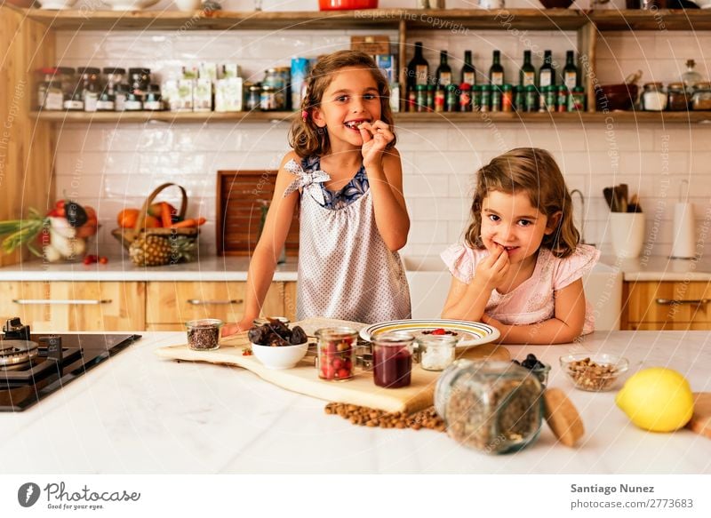 Little sisters girl preparing baking cookies. Child Girl Cooking Kitchen Chocolate Eating savoring Strawberry Daughter Day Happy Joy Family & Relations Love