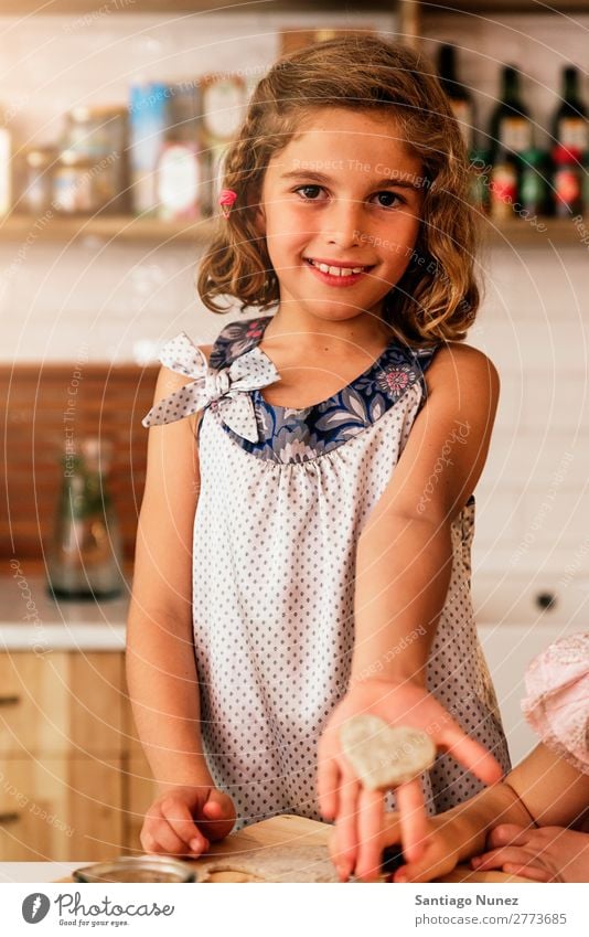 Little girl showing her cookie. Girl Child Nutrition To feed savoring Eating tasting enjoying Portrait photograph Appetite Smiling Laughter Lunch Baby Dirty