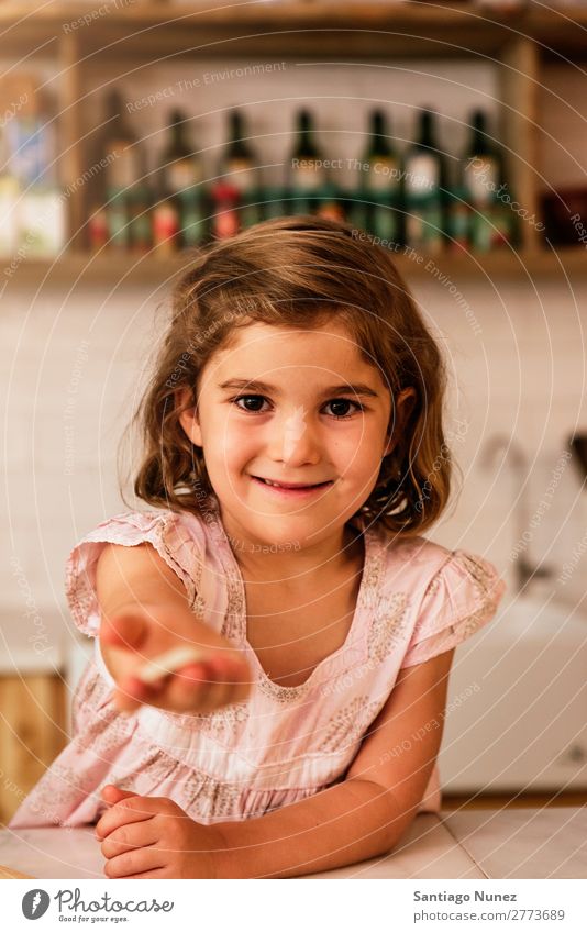 Little girl showing her cookie. Girl Child Nutrition To feed savoring Eating tasting enjoying Portrait photograph Appetite Smiling Laughter Lunch Baby Dirty