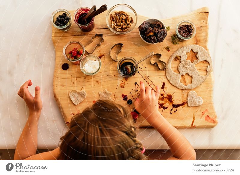 Top view of little girl preparing baking cookies. Girl Child Nutrition Portrait photograph Cooking Kitchen Appetite Preparation Make Lunch Baby Dirty stained