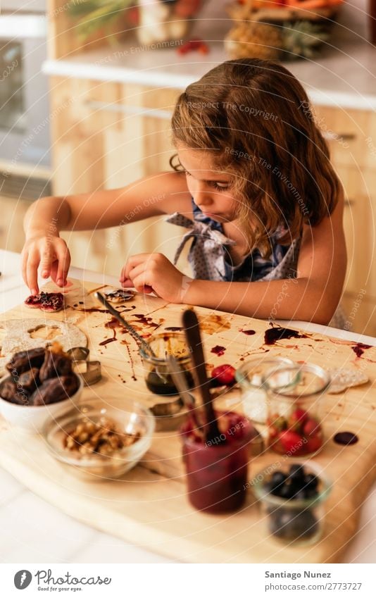 Portrait of little girl preparing baking cookies. Girl Child Nutrition Portrait photograph Cooking Kitchen Appetite Preparation Make Smiling Laughter Lunch Baby