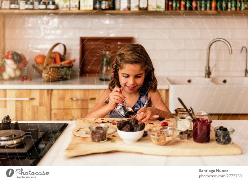 Portrait of little girl preparing baking cookies. Girl Child Nutrition Portrait photograph Cooking Kitchen Appetite Preparation Make Smiling Laughter Lunch Baby