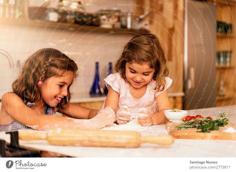 Little sisters girl preparing baking cookies. Child Girl Cooking Kitchen Flour Dough Baking Chocolate Ice cream Strawberry Daughter Day Happy Joy