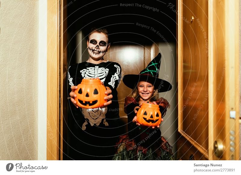 Happy children disguised saying trick or treating. Hallowe'en Child Girl Boy (child) Painting (action, artwork) Skeleton Witch Disguised Joy Family & Relations