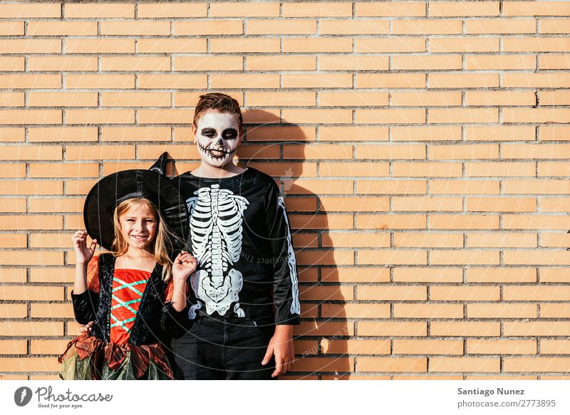 Portrait of children disguised in the street. Hallowe'en Child Girl Boy (child) Painting (action, artwork) Skeleton Witch Joy Family & Relations Sister