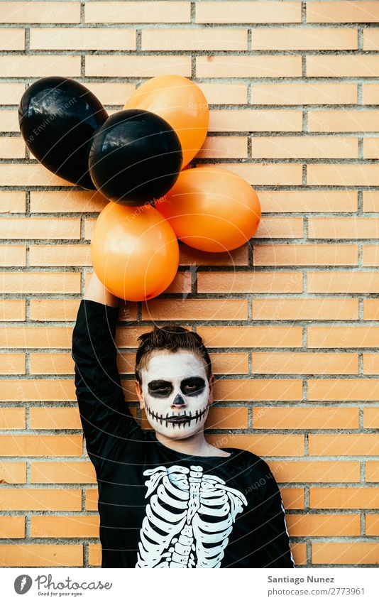 Portrait of boy disguised of skeleton in the street. Hallowe'en Child Boy (child) Painting (action, artwork) Skeleton Joy Family & Relations Brother