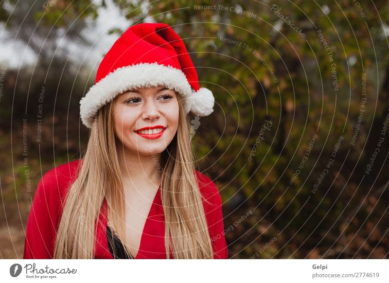 Young woman with Christmas hat in the forest Lifestyle Joy Happy Beautiful Face Calm Winter Christmas & Advent Human being Woman Adults Lips Nature Fog Tree