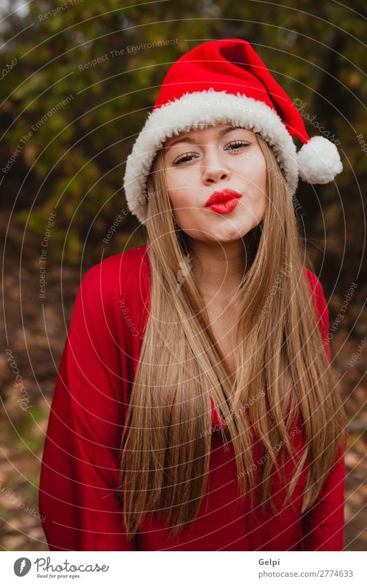 Young woman with Christmas hat in the forest Lifestyle Joy Happy Beautiful Face Calm Winter Christmas & Advent Human being Woman Adults Lips Nature Fog Tree