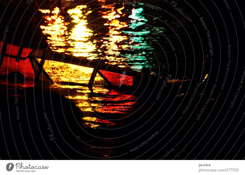 Surfer in the play of light Ocean Beautiful Yellow Red Passion Colour photo Exterior shot Copy Space right Copy Space bottom Night Artificial light Contrast